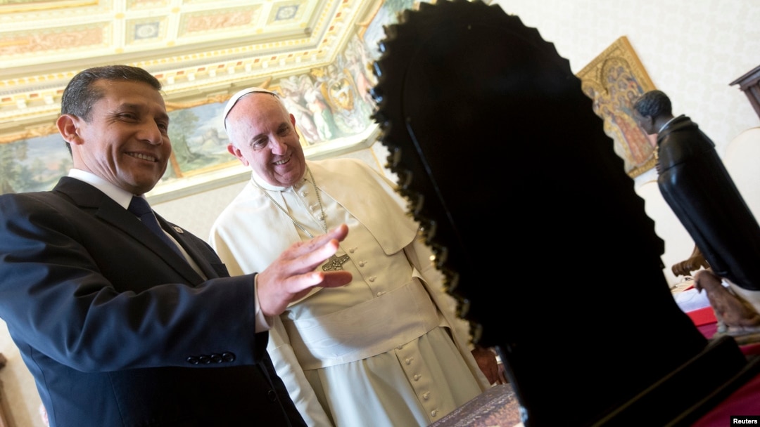 FILE - Pope Francis exchanges gifts with Peru's President Ollanta Humala during a private audience at the Vatican, Nov. 14, 2014.