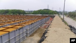 Temporary storage tanks for low and middle level radioactive water from Tokyo Electric Power (TEPCO) Co.'s Fukushima Daiichi Nuclear Power Station's No.1, No.2, No.3 and No.4 reactors are seen at the grounds of the plant in Fukushima prefecture, June 5, 2