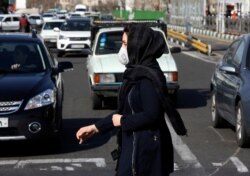 A woman wearing a mask is pictured Tehran, Iran, March 4, 2020. With deaths spiking in Iran and Italy and infections spreading quickly through Europe and elsewhere, countries were considering new measures to curb the new coronavirus.