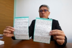 Jesus Loreto, an attorney representing Tomeu Vadell, one of six U.S. oil executives jailed in Venezuela, shows a letter written by Vadell, in Caracas, Venezuela, Nov. 25, 2020.