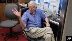 Eric Meyer, publisher of the Marion County Record, talks to one of his reporters in the weekly newspaper's newsroom, Monday, Aug. 21, 2023, in Marion, Kan. 