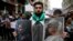 People holding pictures of victims of the airstrikes and shelling in Ghouta, a suburb of Damascus, gather during a rally outside the Russian Consulate in Istanbul, Feb. 22, 2018. 
