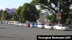 Motorists wait to fill up their tanks at a fuel station in Harare. (AP)