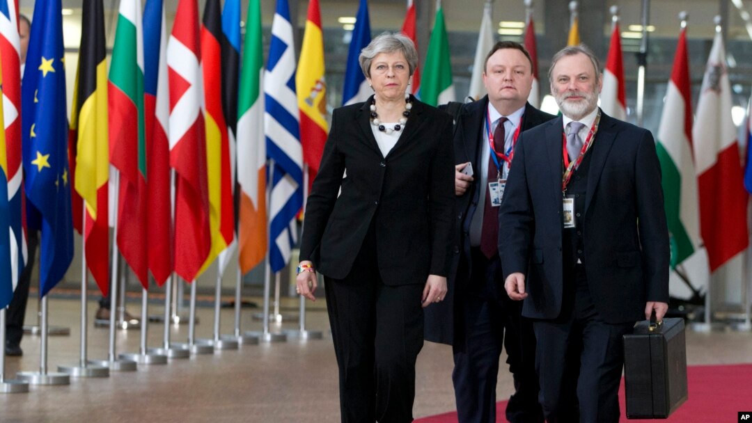 British Prime Minister Theresa May, left, arrives for an EU summit at the Europa building in Brussels, March 23, 2018.