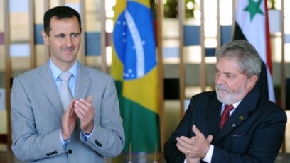 FILE - Syrian President Bashar al-Assad (L) and his Brazilian counterpart Luiz Inacio Lula Da Silva pose for a photograph during a meeting at the Itamaraty Palace in Brasilia, June 30, 2010.