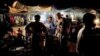 Women purchase grilled chicken from a street vendor in a market in Juba, South Sudan. Outdoor food vendors say inspections by health officials and a drop in clientele during the cholera outbreak are forcing them to shut down. 