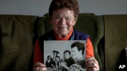 Solveig Leo, 81, former head of a large state-owned farm in the East when Germany was divided, shows a photo of herself from her youth, in the northeastern village of Banzkow, Germany, on Oct. 28, 2024.