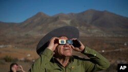 A man looks up at a total solar eclipse in La Higuera, Chile, Tuesday, July 2, 2019. Northern Chile is known for clear skies and some of the largest, most powerful telescopes on Earth are being built in the area, turning the South American country…