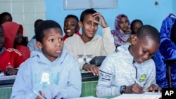 FILE - Boys sit in a classroom at Nouadhibou's Organization for the Support of Migrants and Refugees, Mauritania, Jan. 7, 2025.