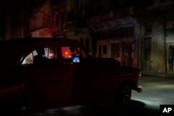 A man drives during a massive blackout after a major power plant failed in Havana, Oct. 18, 2024.