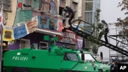 Using a turntable ladder, police officers enter through a window to evict squatters from the "Liebig 34" house, in Berlin, Germany, Oct. 9, 2020.