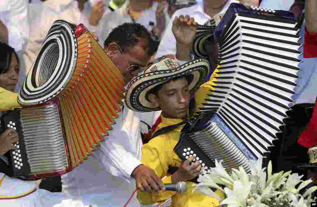 A boy plays the accordion during a musical homage to singer and composer Diomedes Diaz at the main square of Valledupar, in Colombia&#39;s northern state of Cesar, Dec. 25, 2013. Diomedes Diaz, one of the greatest performers of the country&#39;s accordion vallenato music, died on Dec. 22, 2013, at age 56.