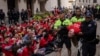 Police officers detain a demonstrator protesting Israel's war against Hamas as they occupy an area outside the New York Stock Exchange, in New York, Oct. 14, 2024