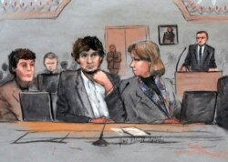 FILE - In this March 5, 2015, courtroom sketch, Dzhokhar Tsarnaev, center, is depicted between defense attorneys Miriam Conrad, left, and Judy Clarke during his federal death penalty trial in Boston.