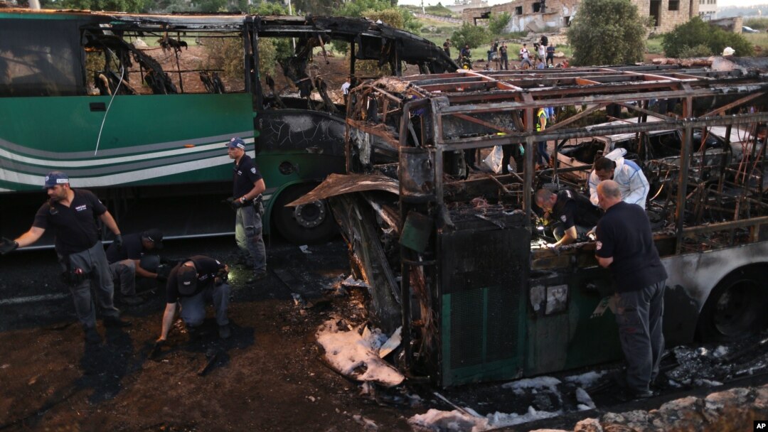FILE - Israeli police officers work at the scene of a bus explosion in Jerusalem, April 18, 2016. One of the 21 people injured in the blast died Wednesday.