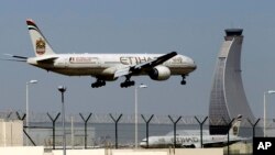 FILE - An Etihad Airways plane prepares to land at the Abu Dhabi airport in the United Arab Emirates, May 4, 2014.