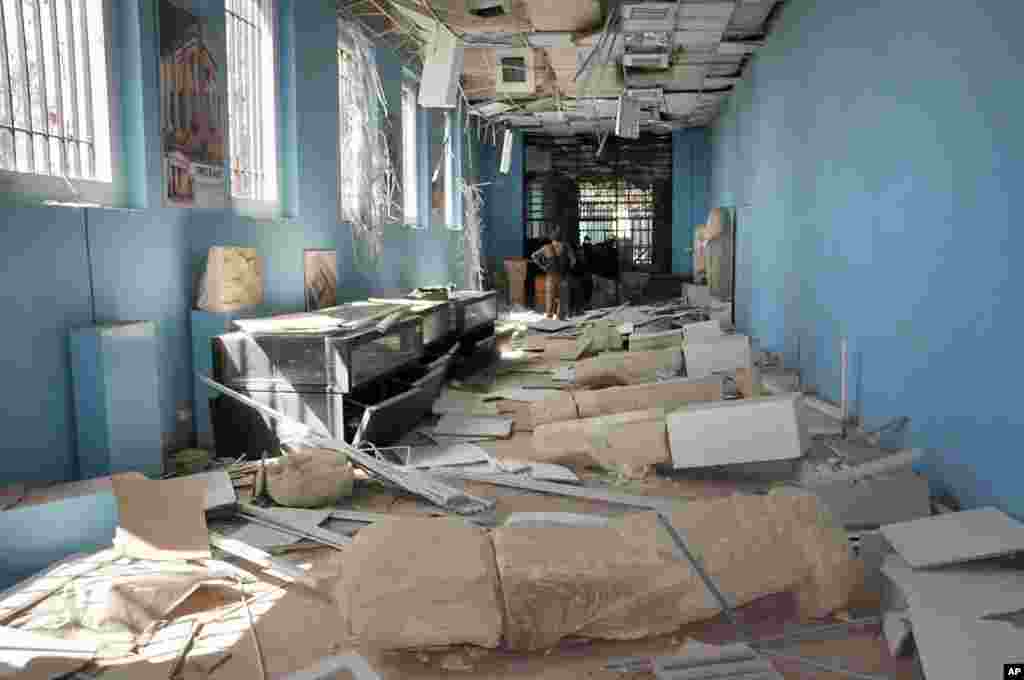 This photo released on Sunday March 27, 2016, by the Syrian official news agency SANA, shows destroyed statues at the damaged Palmyra Museum, in Palmyra city, central Syria. 