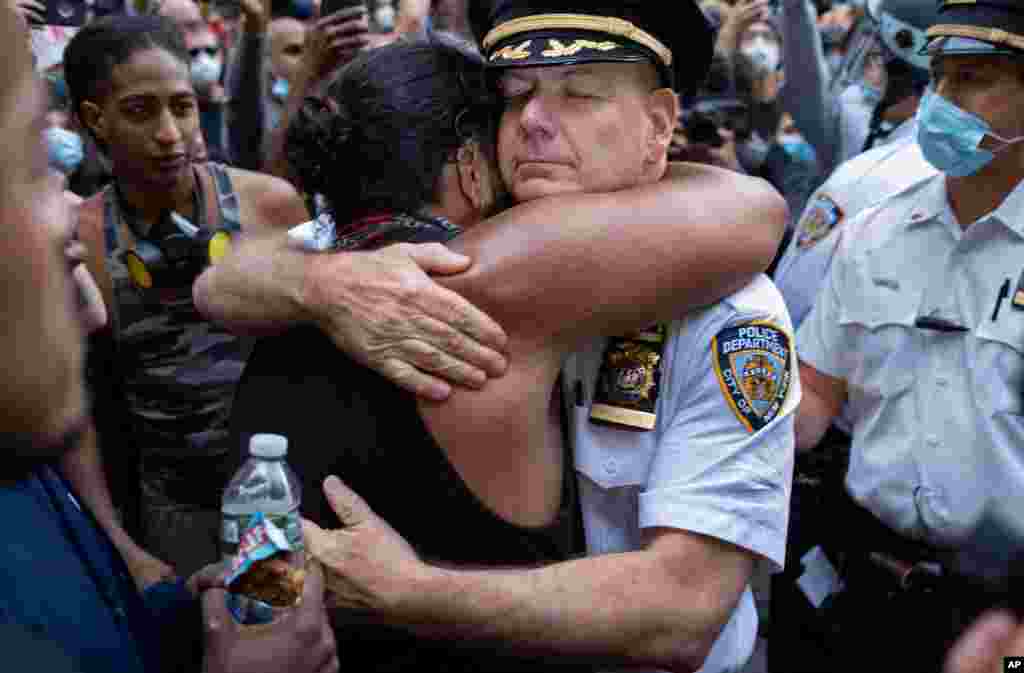 Chief of Department of the New York City Police, Terence Monahan, hugs an activist, June 1, 2020, during a protest the death of George Floyd.