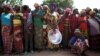 FILE - Women stand in line for food aid in the village of Makunzi Wali, Central African Republic, April 27, 2017.