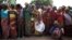 FILE - Women stand in line for food aid in the village of Makunzi Wali, Central African Republic, April 27, 2017.