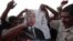 Protesters burn a defaced poster of presidential candidate Ahmed Shafik, ousted leader Hosni Mubarak's last prime minister, at Tahrir square in Cairo June 14, 2012.