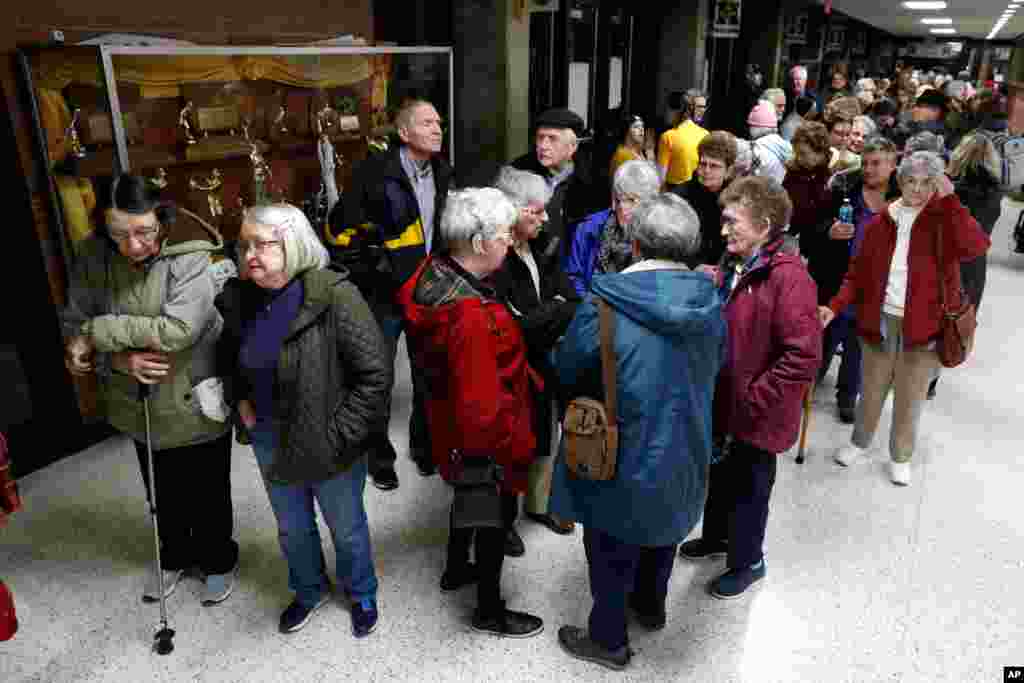 Residents wait to enter an Iowa Democratic caucus at Hoover High School, Feb. 3, 2020, in Des Moines, Iowa.