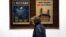 A woman walks past electoral posters in Baku on October 31, 2015, a day ahead of the parliamentary election in Azerbaijan.