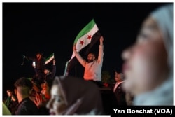 Syrians celebrate the fall of the regime in Damascus, Syria, on Dec. 12, 2024.