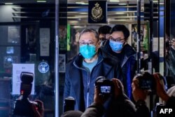 FILE - Hong Kong law professor and pro-democracy activist Benny Tai leaves Ma On Shan Police station following his release on bail in Hong Kong, Jan. 7, 2021.