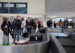 Dutch tourists, who will spend a week long holiday in isolation in their tourist resort as part of an experiment, arrive at the Rhodes International Airport on the island of Rhodes, Greece, amid the COVID-19 outbreak, April 12, 2021.