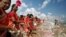 Women scatter flower petals in the waters of the Bay of Bengal during a prayer ceremony for the victims of the 2004 tsunami on the 15th anniversary of the disaster, at Marina beach in Chennai, India.