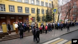 FILE—Voters queue at a polling station at noon local time in Moscow on March 17, 2024.