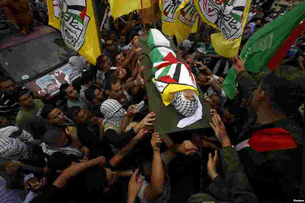 Mourners carry the body of 13-year-old Palestinian boy Abdel-Rahman Abeidallah who was shot by Israeli troops during clashes on Monday, during his funeral in the occupied West Bank city of Bethlehem, Oct. 6, 2015.