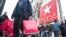 FILE - Shoppers carry bags as they cross a pedestrian walkway near Macy's in Herald Square, in New York. 