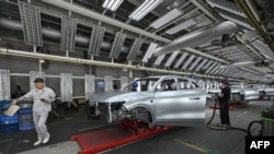 Employees work on an electric vehicle production line at the Leapmotor factory in Jinhua, China's eastern Zhejiang province, on Sept. 18, 2024. 