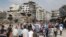 Residents arrive on foot to inspect their homes in the al-Hamdeya neighborhood, after the cessation of fighting between rebels and forces loyal to Syria's President Bashar al-Assad, in Homs city, Syria, May 9, 2014.