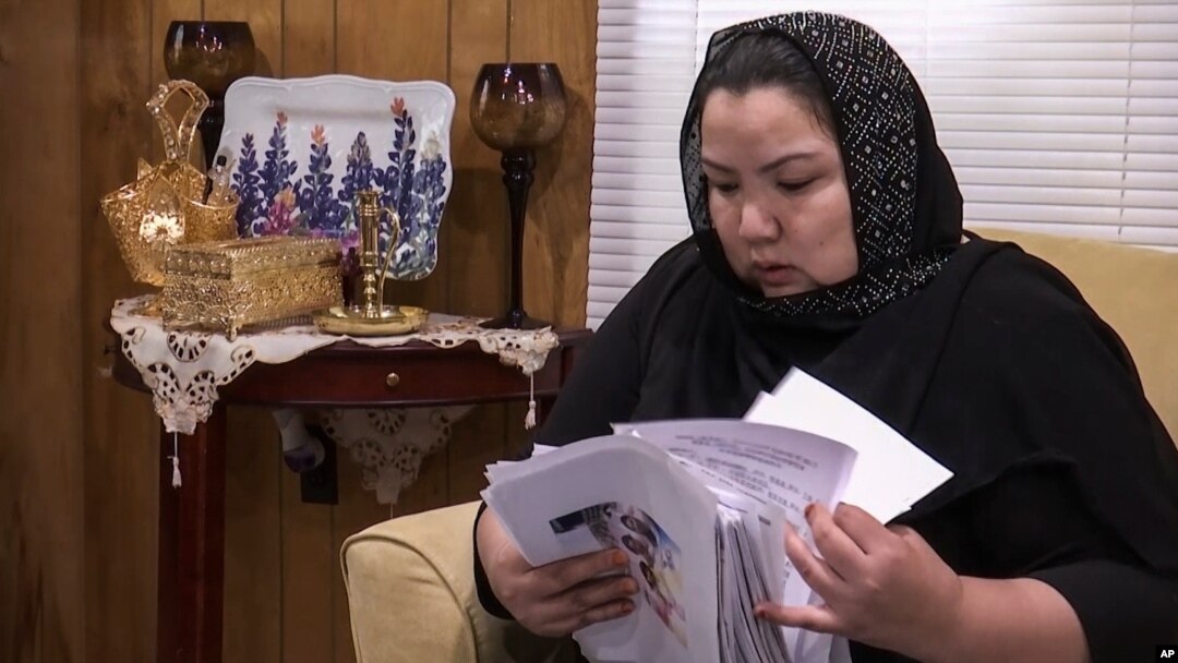 Zumret Dawut, a Uighur from China's Xinjiang region, who holds documents she brought with her, at her new home in Woodbridge, Va., June 15, 2020, says she was forcibly sterilized for having a third child.