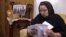 In this image from video, Zumret Dawut, a Uighur from China's far western Xinjiang region, holds documents she brought with her, at her new home in Woodbridge, Va., on Monday, June 15, 2020. Dawut says in China, she was forcibly sterilized for…