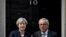 FILE - Britain's Prime Minister Theresa May welcomes Head of the European Commission, President Jean-Claude Juncker to Downing Street in London, April 26, 2017. 
