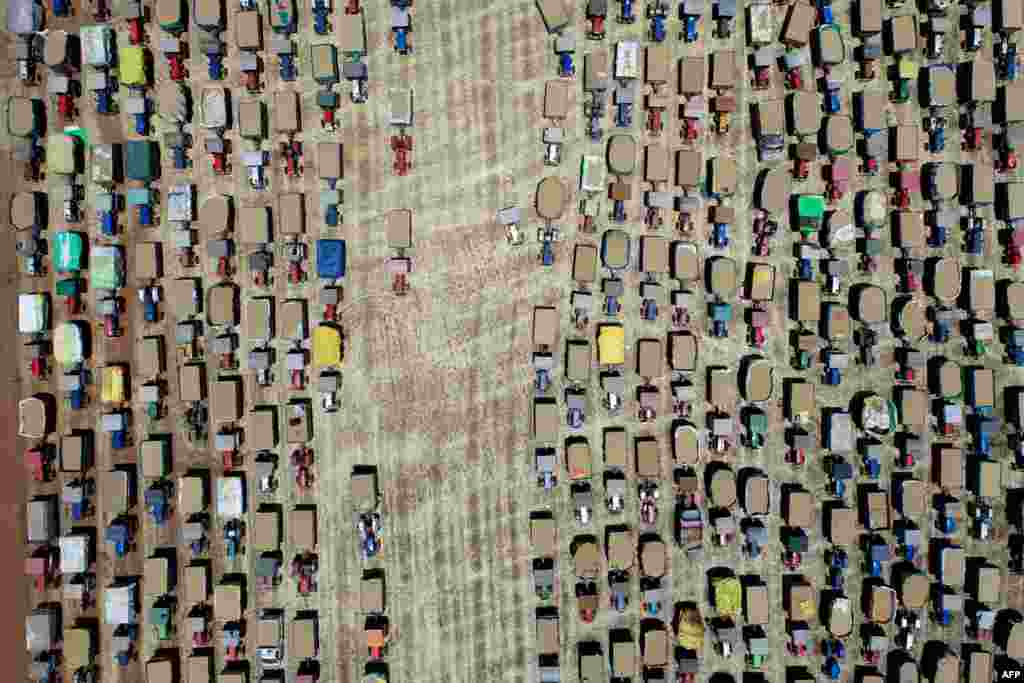 Farmers line up their tractors carrying wheat grain at a wholesale market , at Majholi Tehsil village, some 45 km from Jabalpur, India.