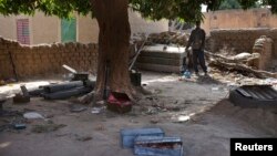  Local resident Issa Dembele stands next to munitions, believed to belong to Islamist rebels, stockpiled in the courtyard of his house in Diabaly, Mali, Jan. 23, 2013.