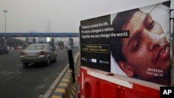 FILE - An anti-tobacco warning is seen on a road divider on the outskirts of New Delhi, India, Nov. 4, 2016.