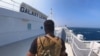 FILE - A Houthi fighter stands on the Galaxy Leader cargo ship in the Red Sea in this photo released Nov. 20, 2023. (Houthi Military Media/Handout via Reuters)