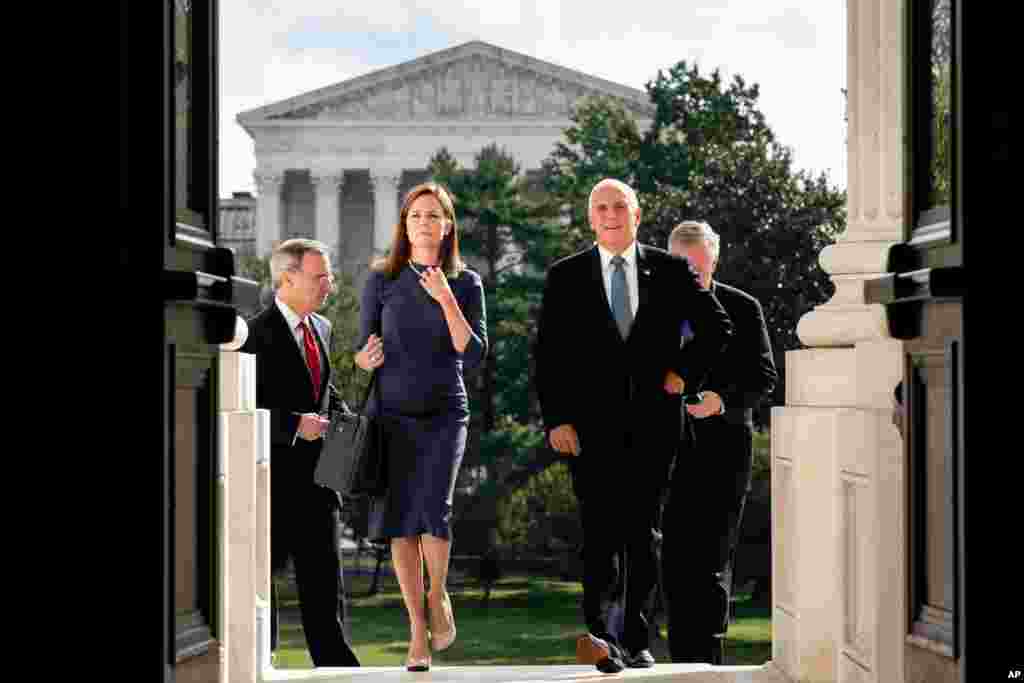 Judge Amy Coney Barrett, President Donald Trump&#39;s nominee to the Supreme Court, left, and Vice President Mike Pence arrive at the Capitol, where Barrett will meet with Senators in Washington.