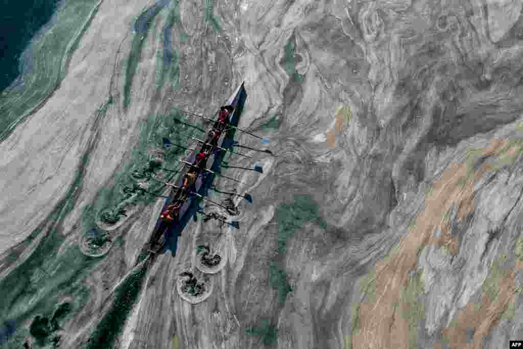 This aerial photograph taken from above the Caddebostan shore of Turkey&#39;s Marmara Sea, June 8, 2021, shows a boat sailing in mucilage, a jelly-like layer of slime on the surface of the water due to the excessive proliferation of phytoplankton.