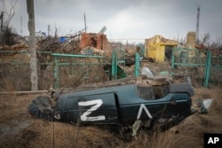 FILE—A damaged car with the symbol of the Russian troops is seen in the village of Kamenka, Kharkiv region, Ukraine, March 17, 2024.
