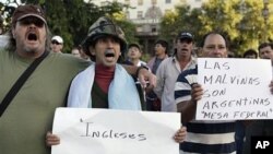 Falklands war veterans, one holding up a sign that reads in Spanish 'The islands are Argentine,' referring to the Falklands islands, demonstrate in front of the National Congress in Buenos Aires (File Photo)