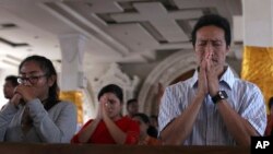 Worshipers pray during Christmas eve mass service at the cathedral in Bali, Indonesia, Dec. 24, 2016. 