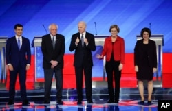 Senators Elizabeth Warren, D-Mass., and Amy Klobuchar, D-Minn., (right) on the debate stage in New Hampshire with the other Democratic presidential hopefuls, Feb. 7, 2020.