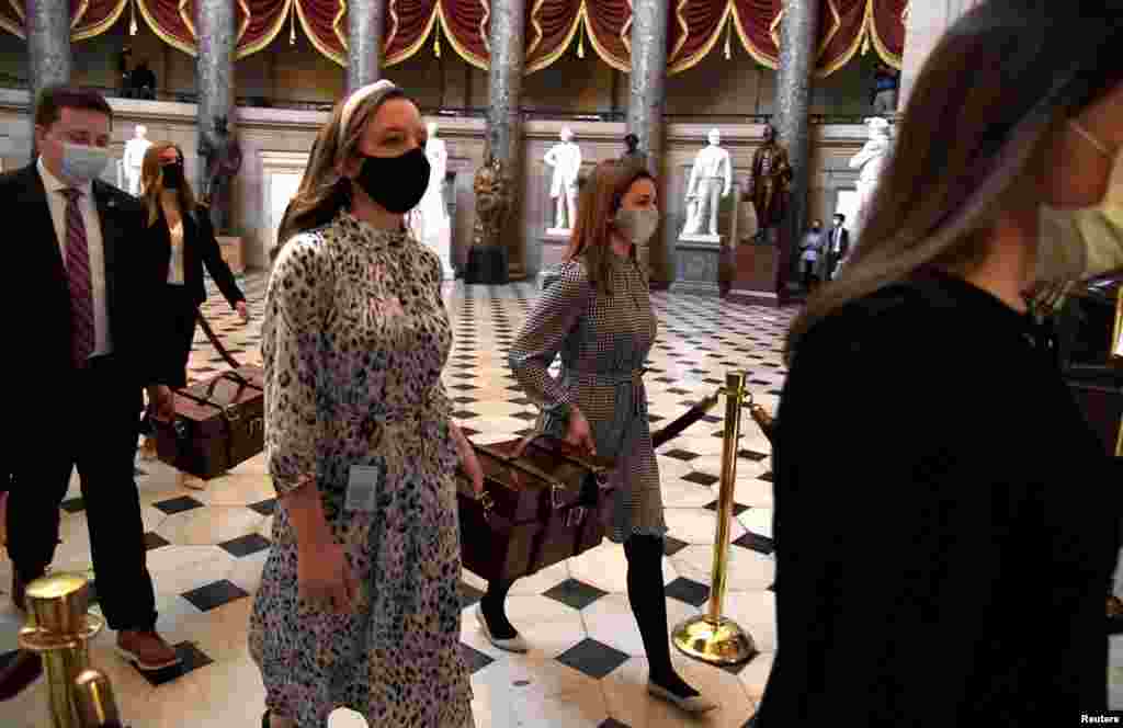 Electoral College ballot boxes are carried to the House of Representatives at the U.S. Capitol where Congress will meet in joint session to certify the 2020 election results, in Washington, D.C., Jan. 6, 2021.